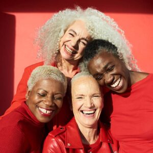 Group of multicutural women wearing red